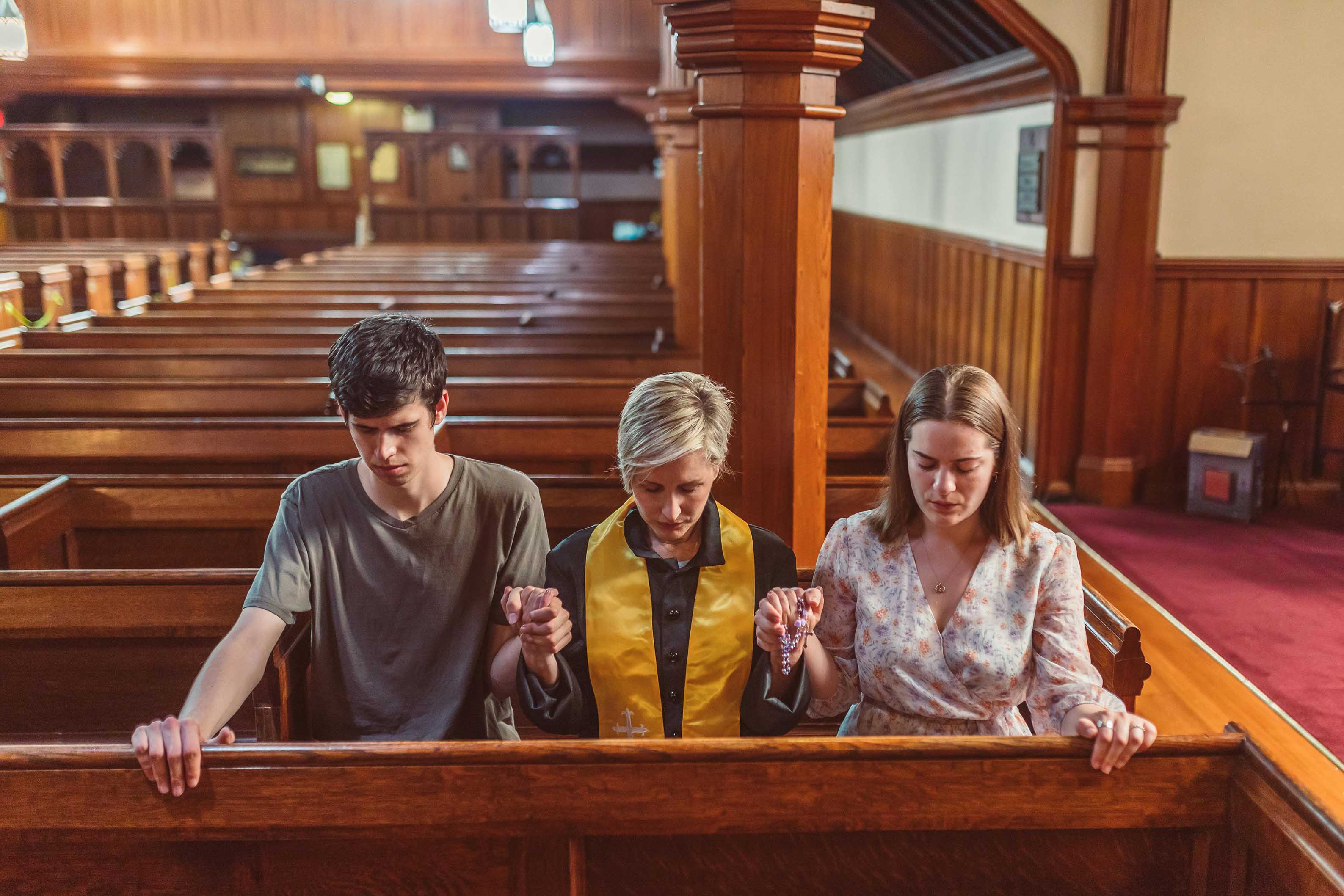 People praying together in a church pew